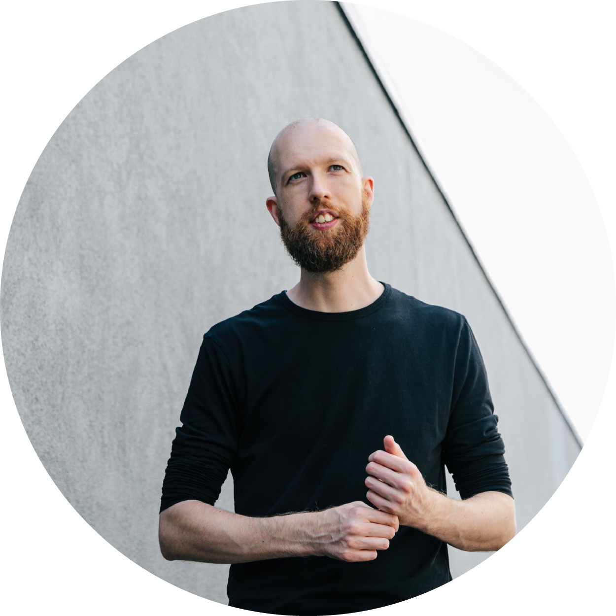 Thom Baker, Certified Brand Strategy Consultant stood in front of sustainable building