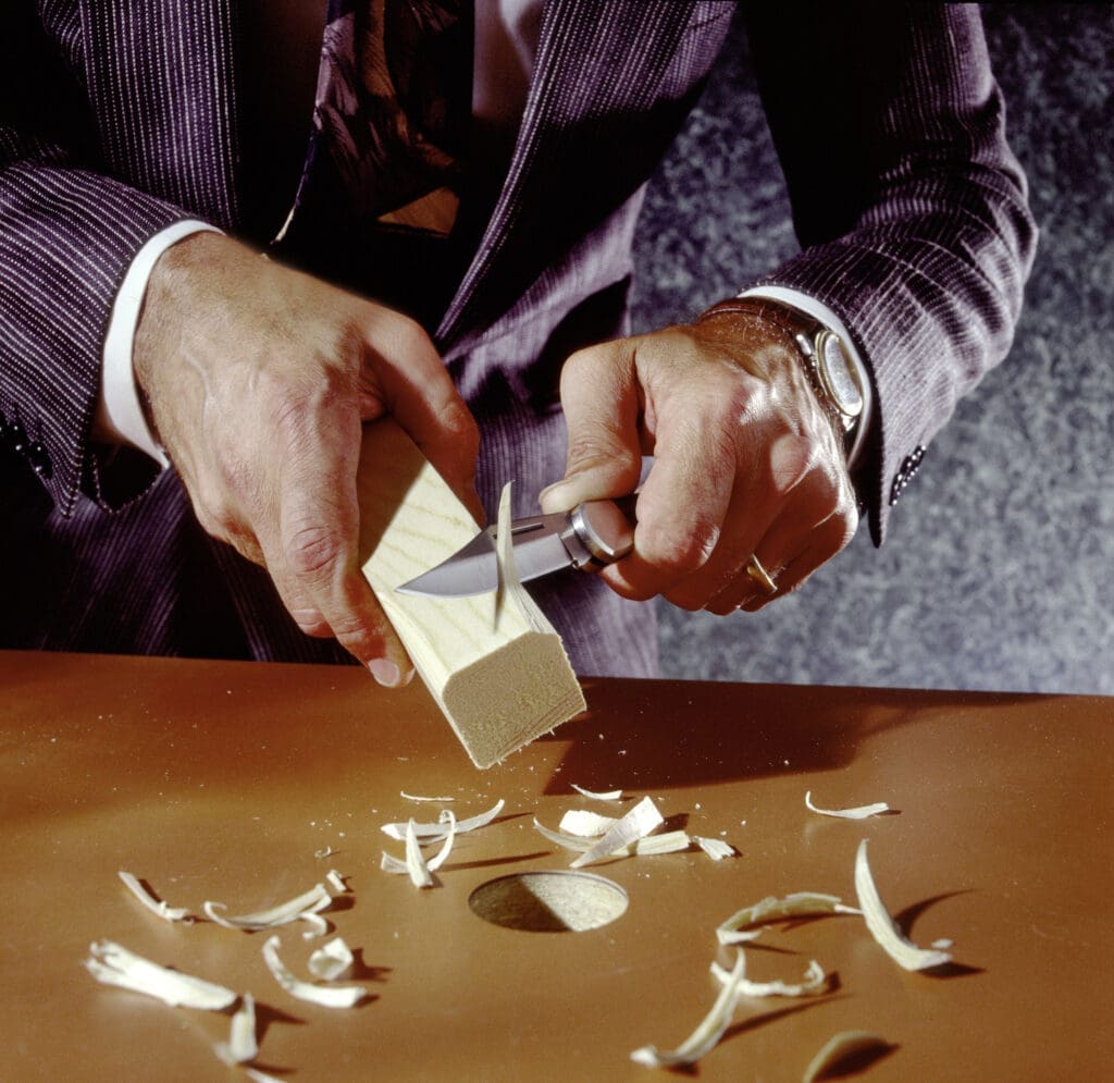 Man carving square peg to fit round hole wearing suit Thom Baker Consultancy