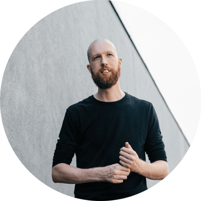 Thom Baker, Certified Brand Strategy Consultant stood in front of sustainable building
